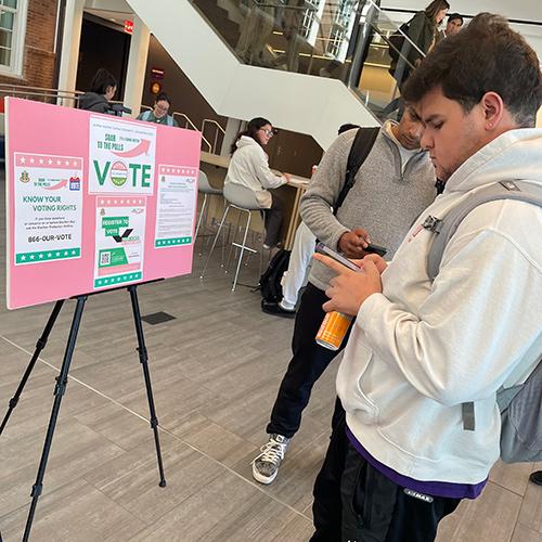 A student registers to vote on his phone.