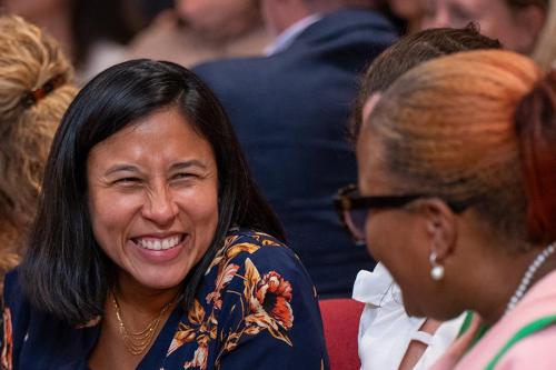 An employee smiles at Faculty Convocation.