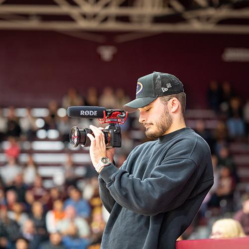 A camera man at a basketball game.