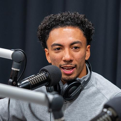 A student interviewing in the podcast studio.