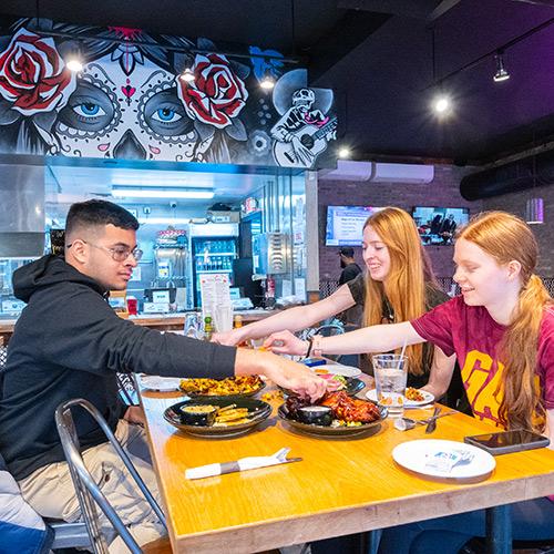 Students enjoy lunch at a taco shop.