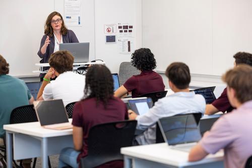 A teacher in front of a classroom of students.