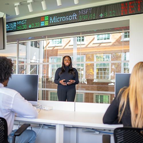 A student gives a presentation on the trading floor.