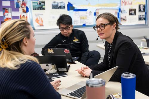 Christine Hardigree works with a teacher at the AI@Iona meeting.